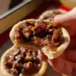 Crumbl Pecan Pie Cookies with caramel and pecans on a plate