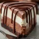 A slice of creamy cheesecake garnished with fresh berries