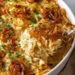 Delicious French Onion Chicken Orzo Casserole topped with melted cheese