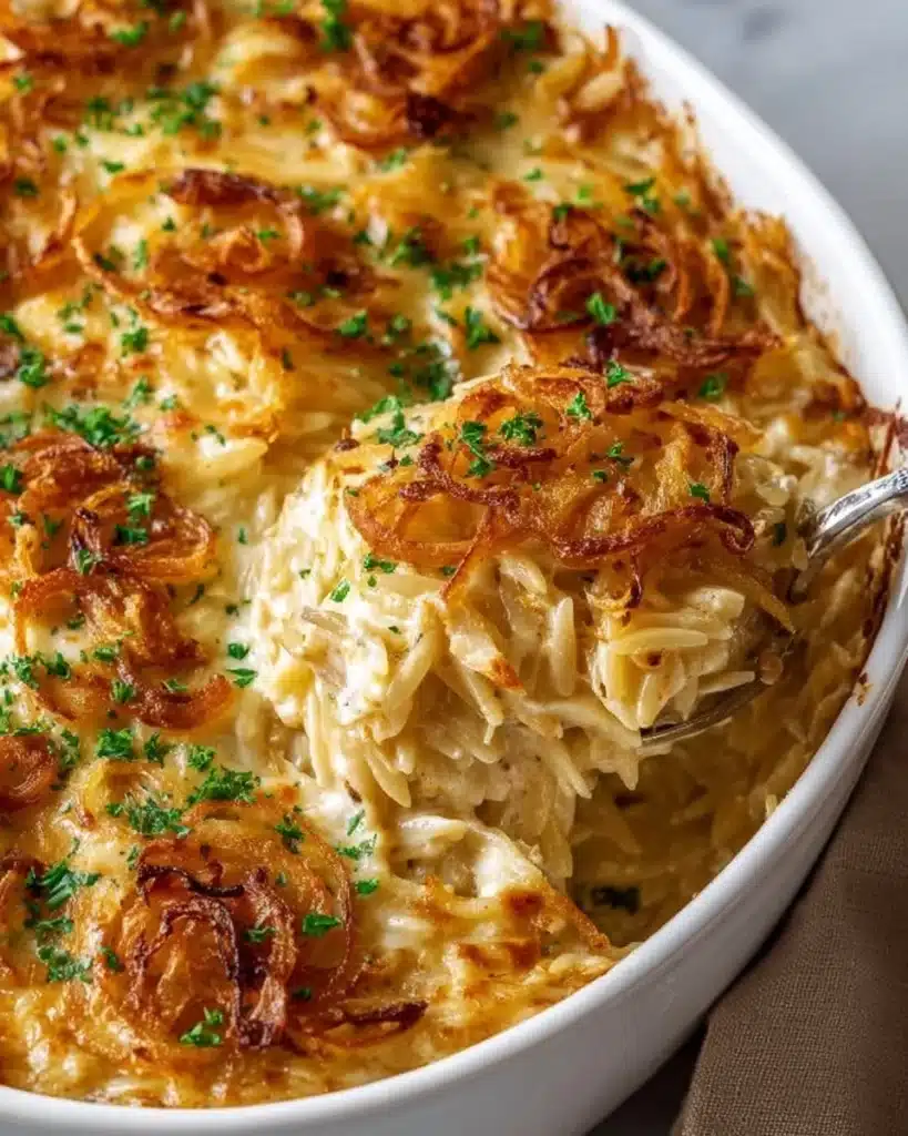 Delicious French Onion Chicken Orzo Casserole topped with melted cheese