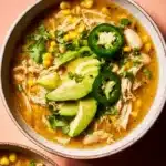 Bowl of healthy white chicken chili topped with fresh herbs