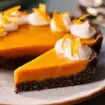 Delicious slice of Honey Carrot Pie topped with fresh cream