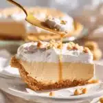 Delicious no-bake butterscotch pie topped with whipped cream and chocolate shavings.