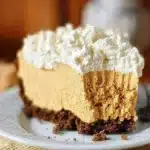 No-Bake Pumpkin Silk Pie garnished with whipped cream and spices