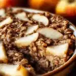 Baked oatmeal with apples, served in a warm dish, perfect for breakfast.