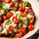 One Pan Balsamic Chicken served with vegetables on a rustic wooden table.