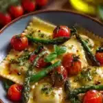 Ravioli with tomatoes and asparagus garnished with fresh herbs