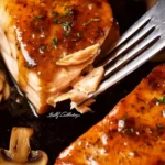 Brown Sugar Glazed Salmon fillet garnished with herbs