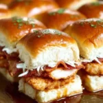Chicken Bacon Ranch Sliders on a plate, garnished with fresh herbs