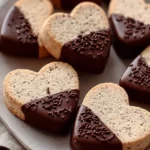 Chocolate dipped linzer cookies on a cooling rack