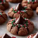 Delicious Chocolate Thumbprint Cookies filled with chocolate ganache on a baking sheet.