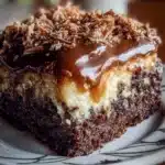 Delicious German chocolate poke cake topped with coconut frosting