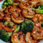High-protein honey garlic shrimp served with vegetables on a plate.