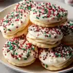 Holiday white chocolate sandwich cookies with festive decorations