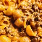 A delicious bowl of homemade Hamburger Helper garnished with fresh herbs.