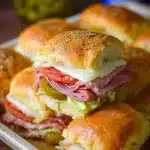 Delicious hot Italian sub sliders with meats and cheese on a rustic plate
