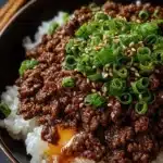 Korean Ground Beef Bowl topped with vegetables and served with rice