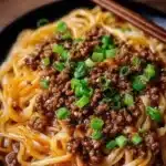 Plate of Mongolian Ground Beef Noodles garnished with green onions