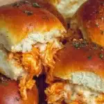 Spicy Buffalo Chicken Sliders served with ranch dressing and garnished with celery.