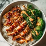 Sticky chicken rice bowls served with vibrant vegetables and delicious sauce