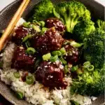 Sticky Mongolian Beef Meatballs in a savory sauce served on a plate.