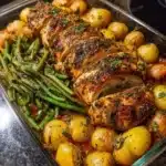 Baked Herb Chicken served with roasted potatoes and sautéed green beans