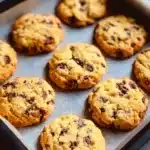 Chocolate chip and toffee shortbread cookies on a baking sheet