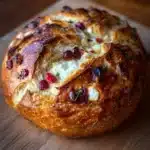 Freshly baked cranberry goat cheese sourdough loaf with a crispy crust