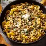 Creamy turkey stroganoff served over egg noodles with fresh herbs.