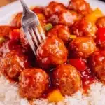 Crockpot Pineapple BBQ Meatballs served in a bowl with sauce and garnished.
