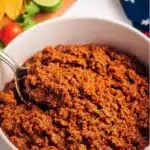 Delicious crockpot taco meat served in a taco shell with toppings.