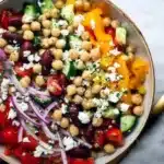 A vibrant Greek Chickpea Salad with fresh vegetables and feta cheese.