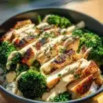 Grilled chicken and broccoli bowls topped with creamy garlic sauce