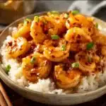 Delicious honey garlic shrimp served on a plate with fresh herbs