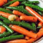 Delicious honey glazed carrots and green beans served on a plate.