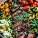 Mediterranean steak bowl with fresh vegetables and flavorful ingredients