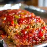 Delicious sausage and peppers meatloaf served with vegetables