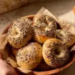 Freshly baked sourdough discard bagels on a cooling rack