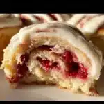 Freshly baked sourdough raspberry lemon rolls on a wooden board