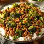 Plate of Teriyaki Ground Turkey with Broccoli and Peas garnished with sesame seeds
