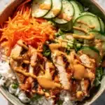Thai Peanut Chicken Buddha Bowl with fresh veggies and peanut sauce