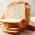 Loaf of sourdough sandwich bread on a wooden cutting board