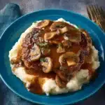 Turkey Salisbury Steaks served with creamy mushroom gravy on a plate