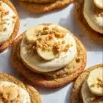 Banana pudding cookies fresh out of the oven on a cooling rack.