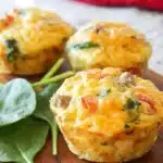Cheesy Sausage Egg Breakfast Muffins on a wooden table