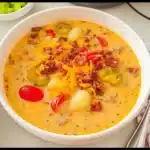 Bowl of creamy crockpot cheeseburger soup with toppings