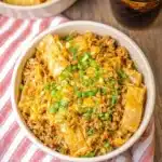 Crockpot egg roll in a bowl with vegetables and seasonings