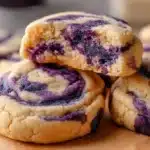 Delicious easy blueberry cheesecake swirl cookies on a rustic table.