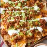 Family-friendly sloppy joe loaded nachos topped with cheese and toppings