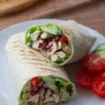 Gourmet grilled chicken wrap with fresh vegetables and sauce